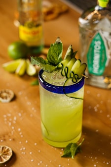 a glass of lemonade sitting on top of a wooden table