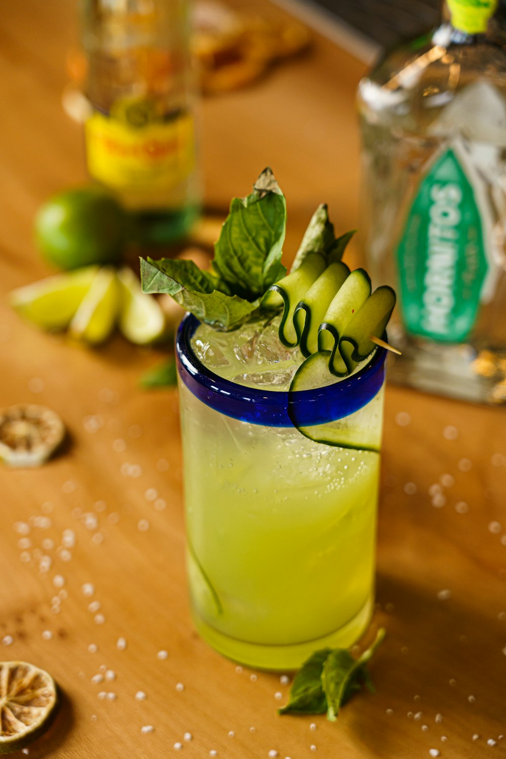 a glass of lemonade sitting on top of a wooden table