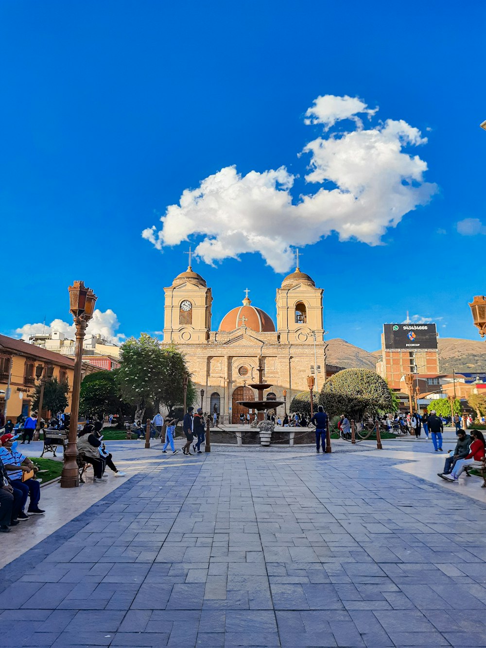 a group of people sitting on benches in front of a building