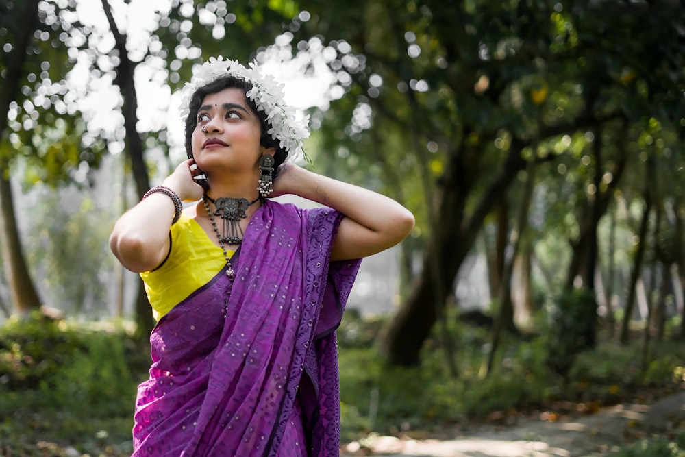 a woman in a purple sari talking on a cell phone