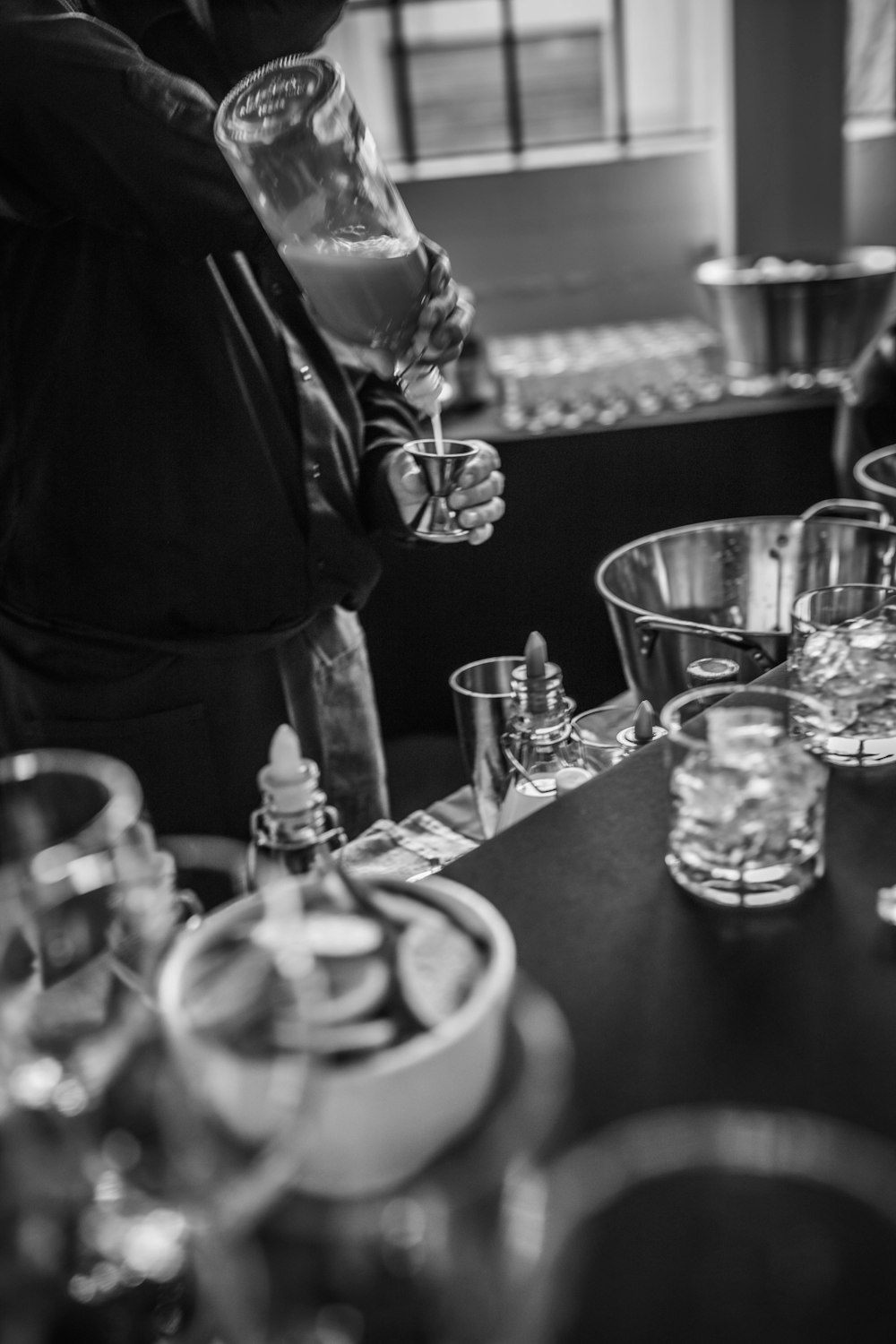 a black and white photo of a person holding a wine glass