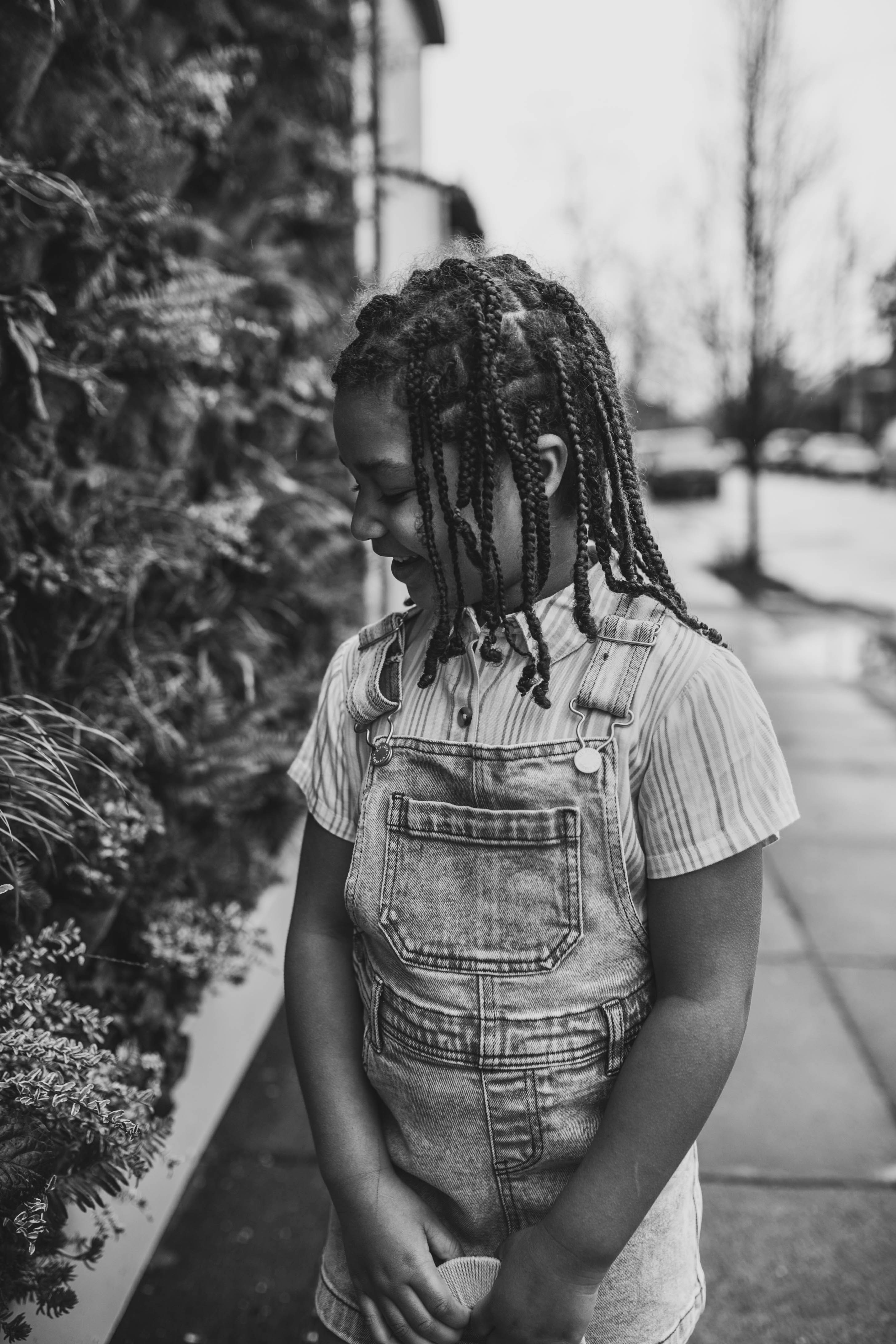 a black and white photo of a person with dreadlocks