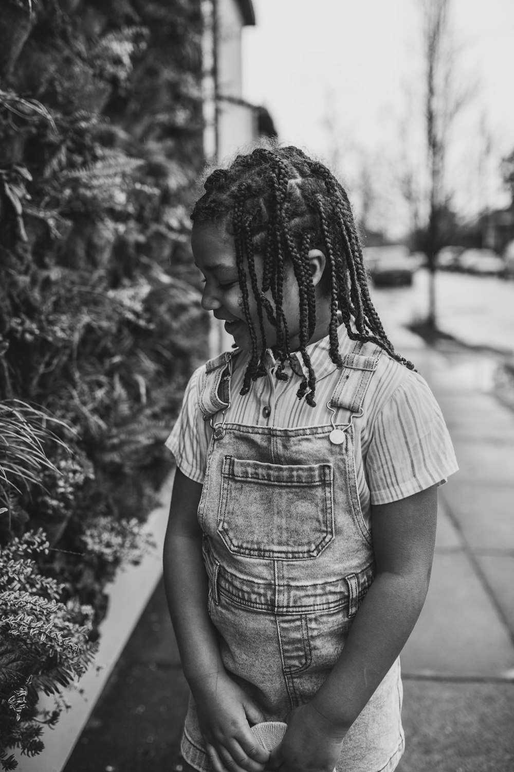 a black and white photo of a person with dreadlocks