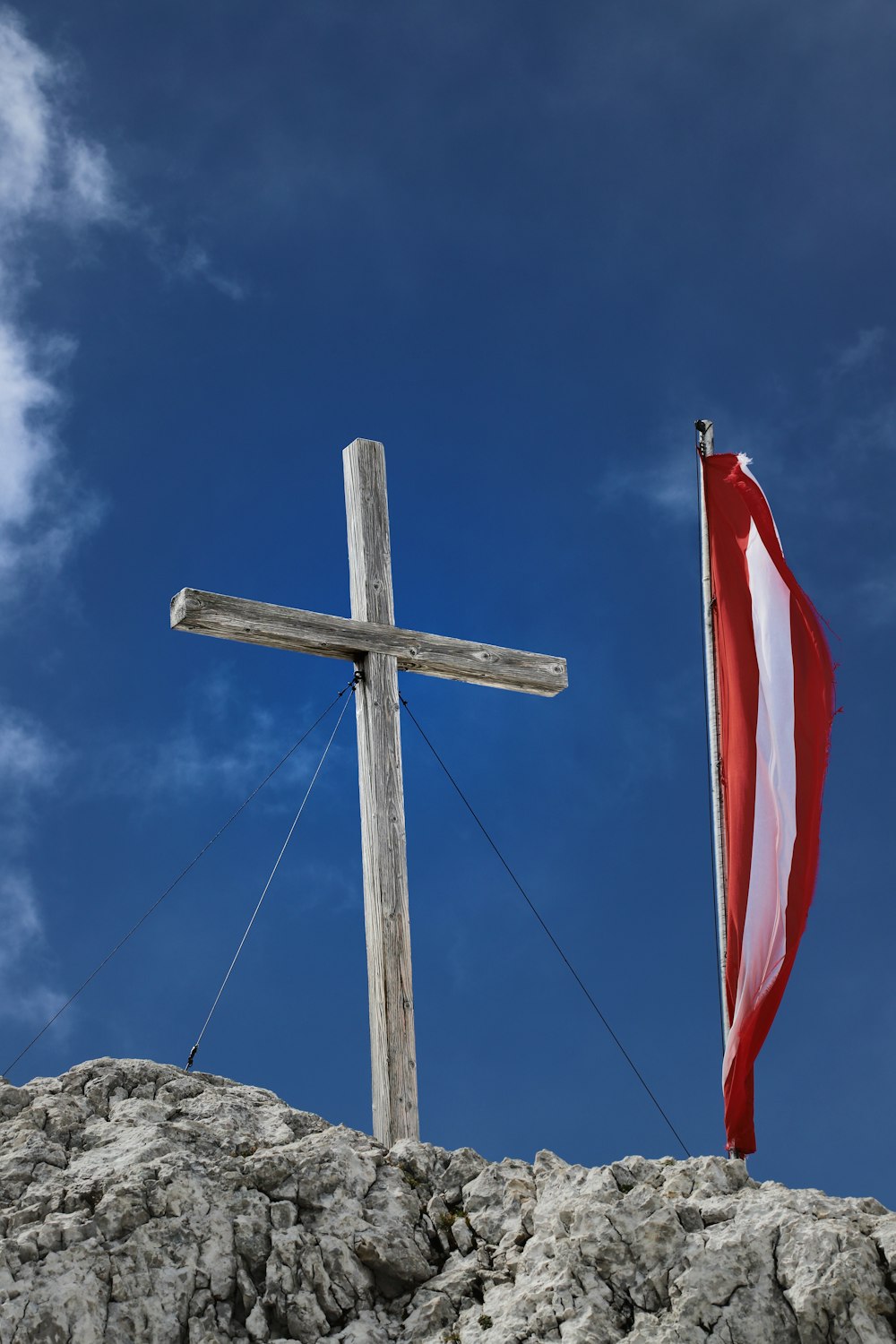 a cross and a flag on top of a hill