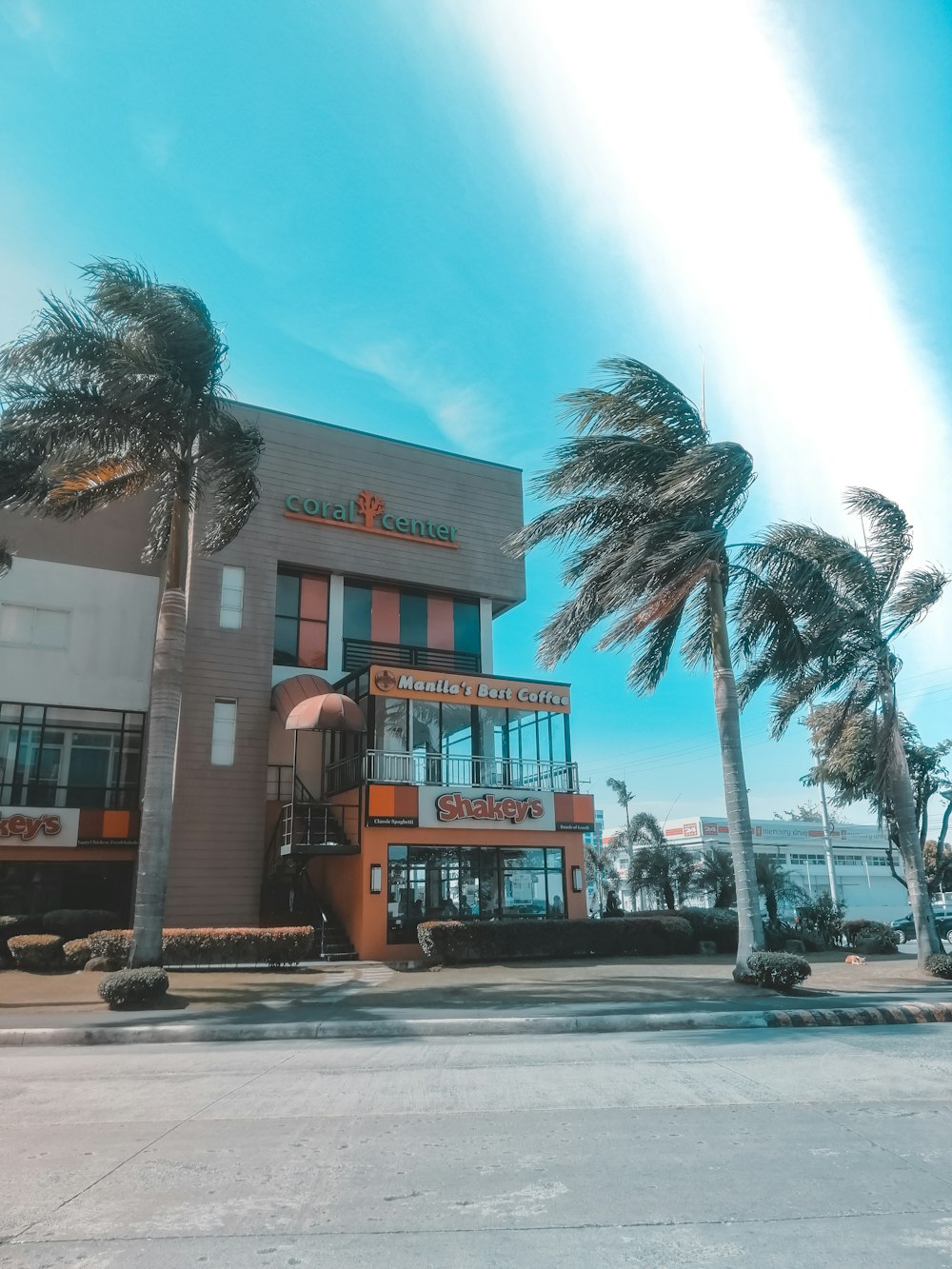 a building with palm trees in front of it