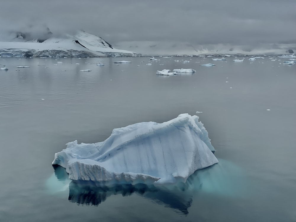 a large iceberg floating on top of a body of water