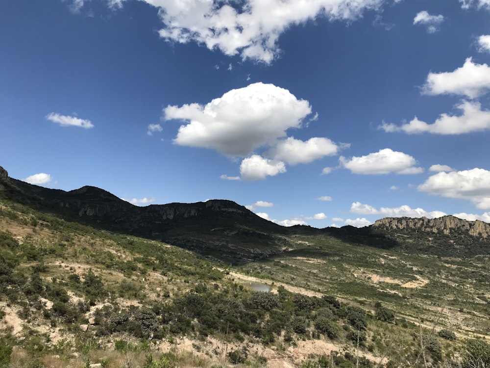 a view of a mountain range with clouds in the sky