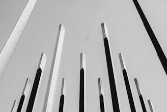 A towering abstract piece made from reclaimed steel beams against a minimalist backdrop.