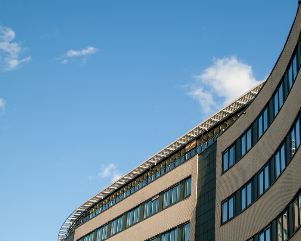 a tall building with lots of windows and a sky background