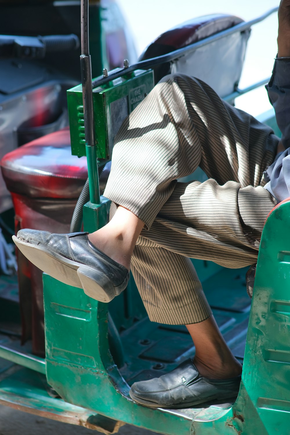 a man sitting on the back of a green truck