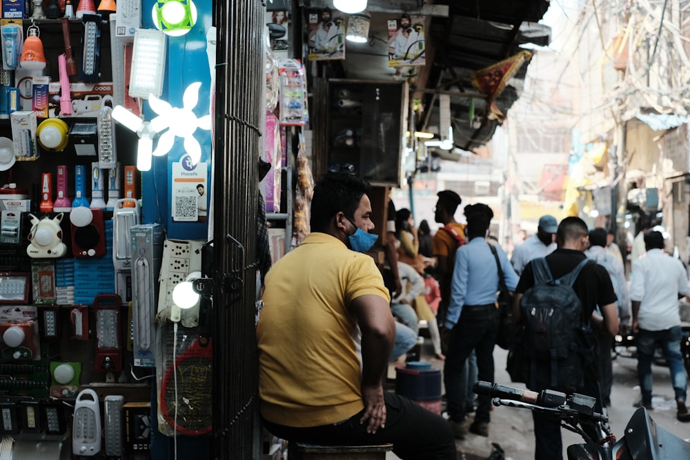 a man sitting on a bench in front of a store