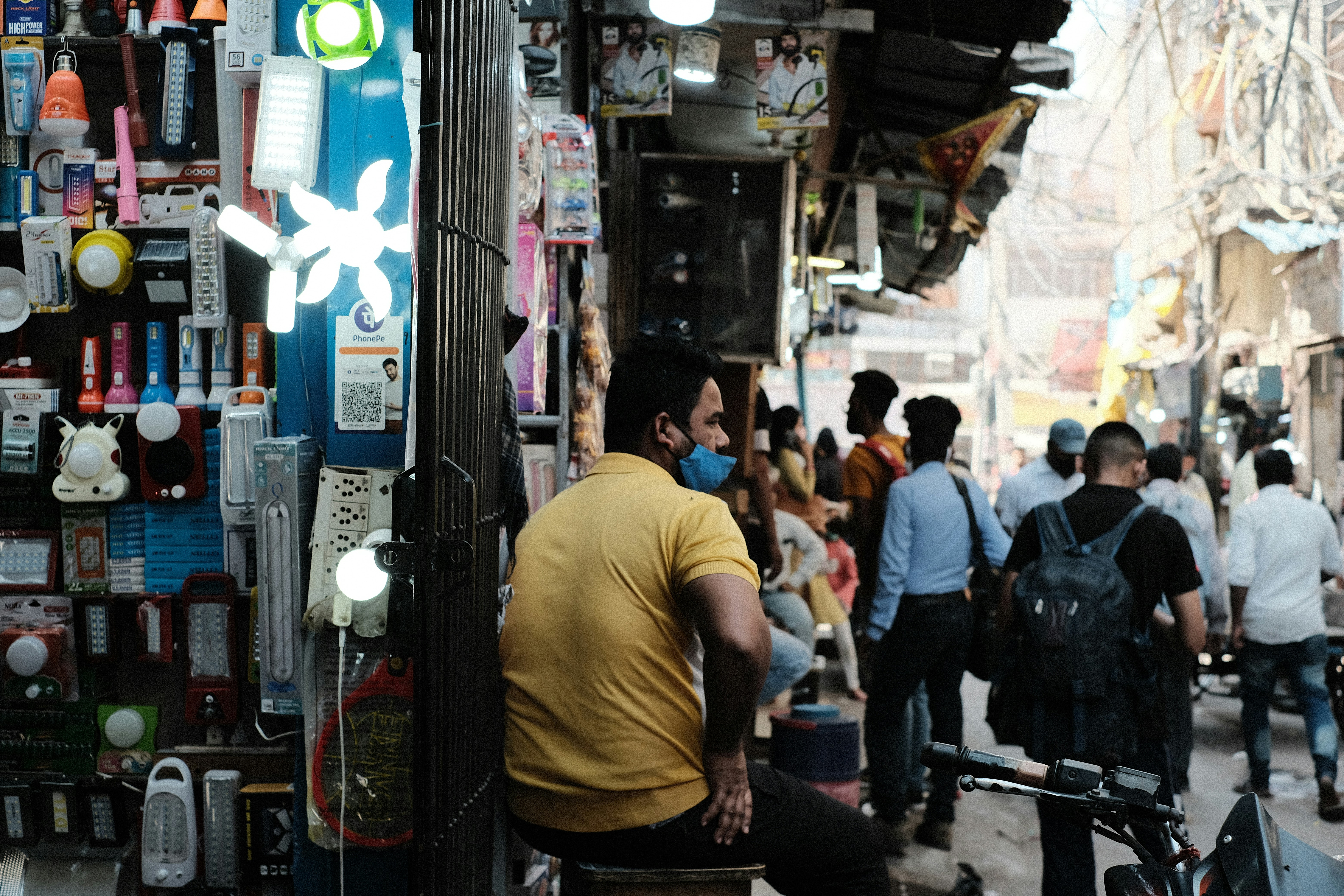 a man sitting on a bench in front of a store