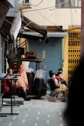 a group of people sitting outside of a building