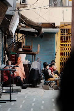 a group of people sitting outside of a building
