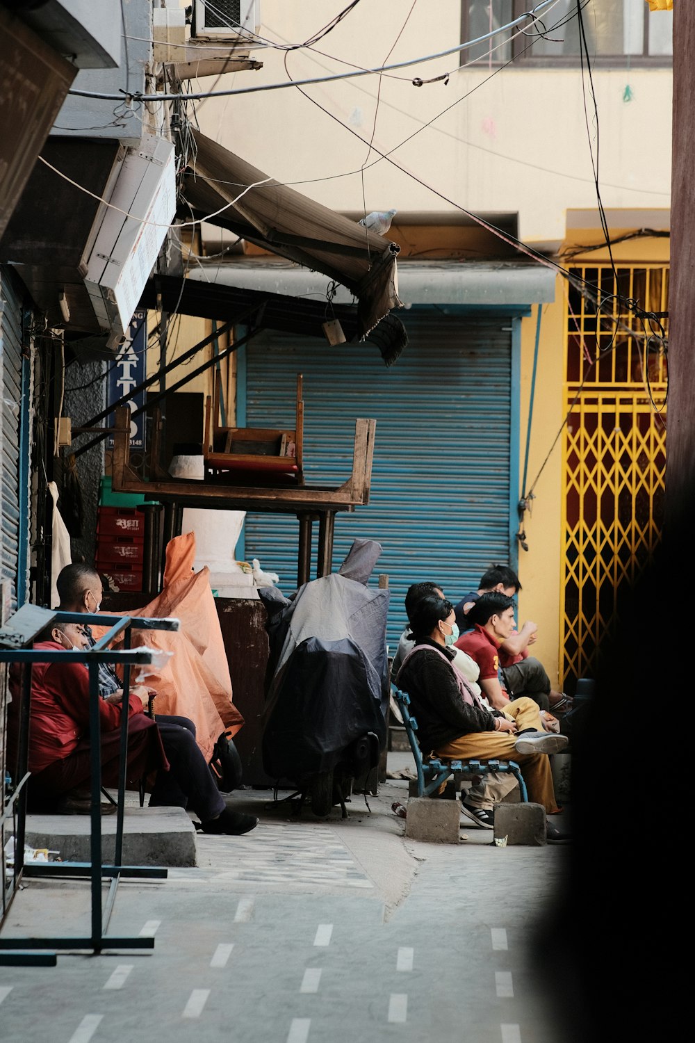 a group of people sitting outside of a building