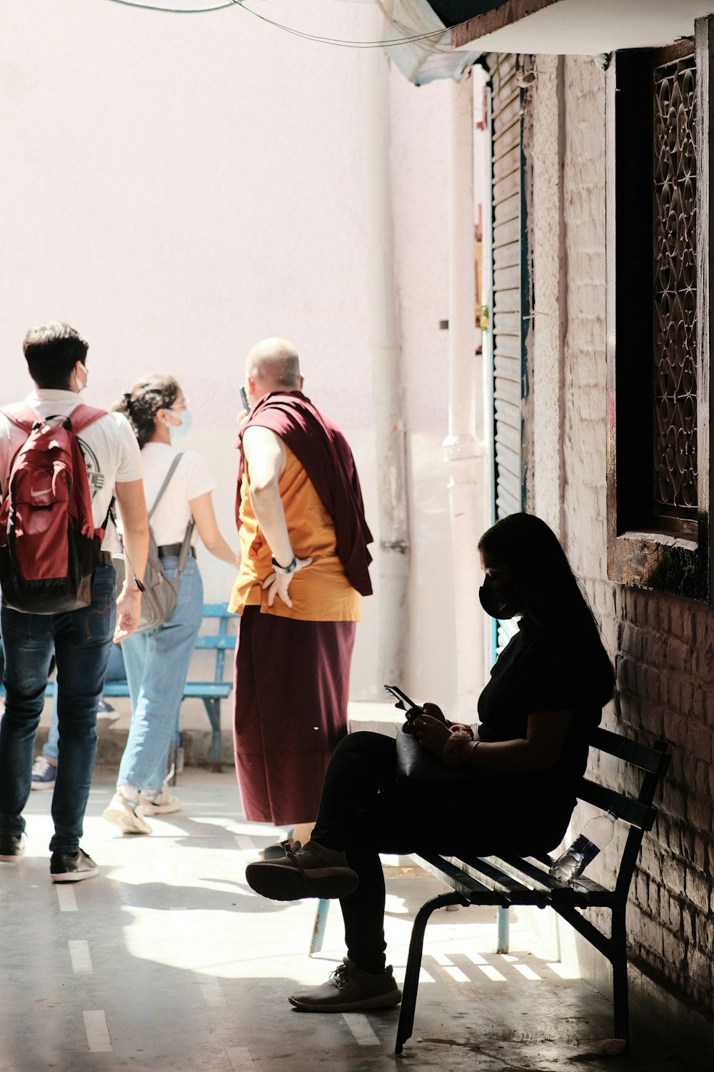 a group of people standing and sitting around a building