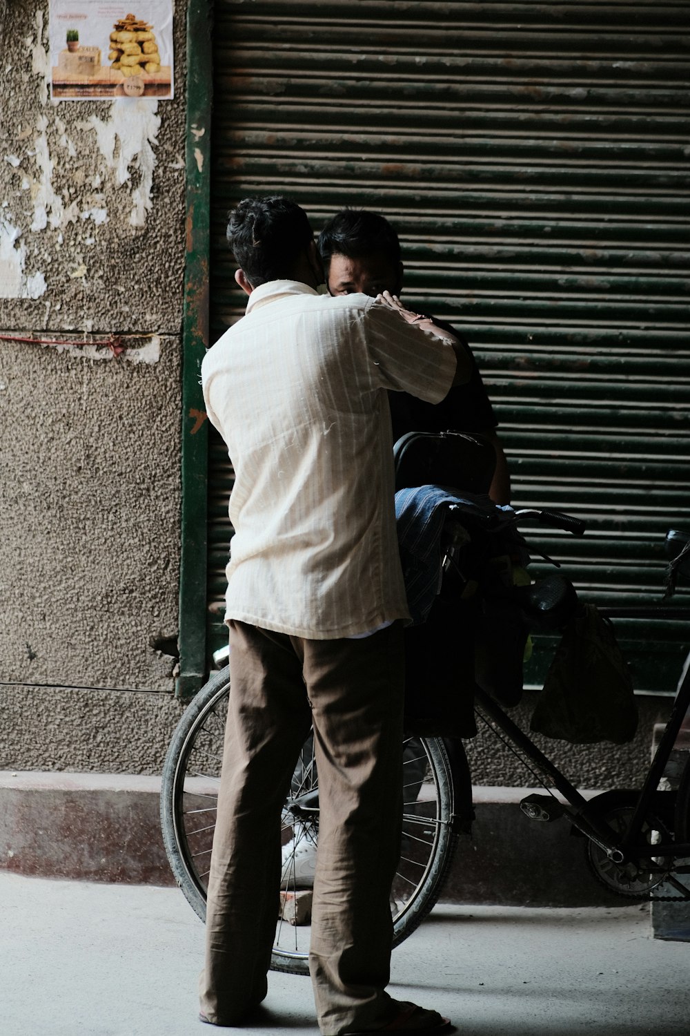 a man standing next to a woman on a bike