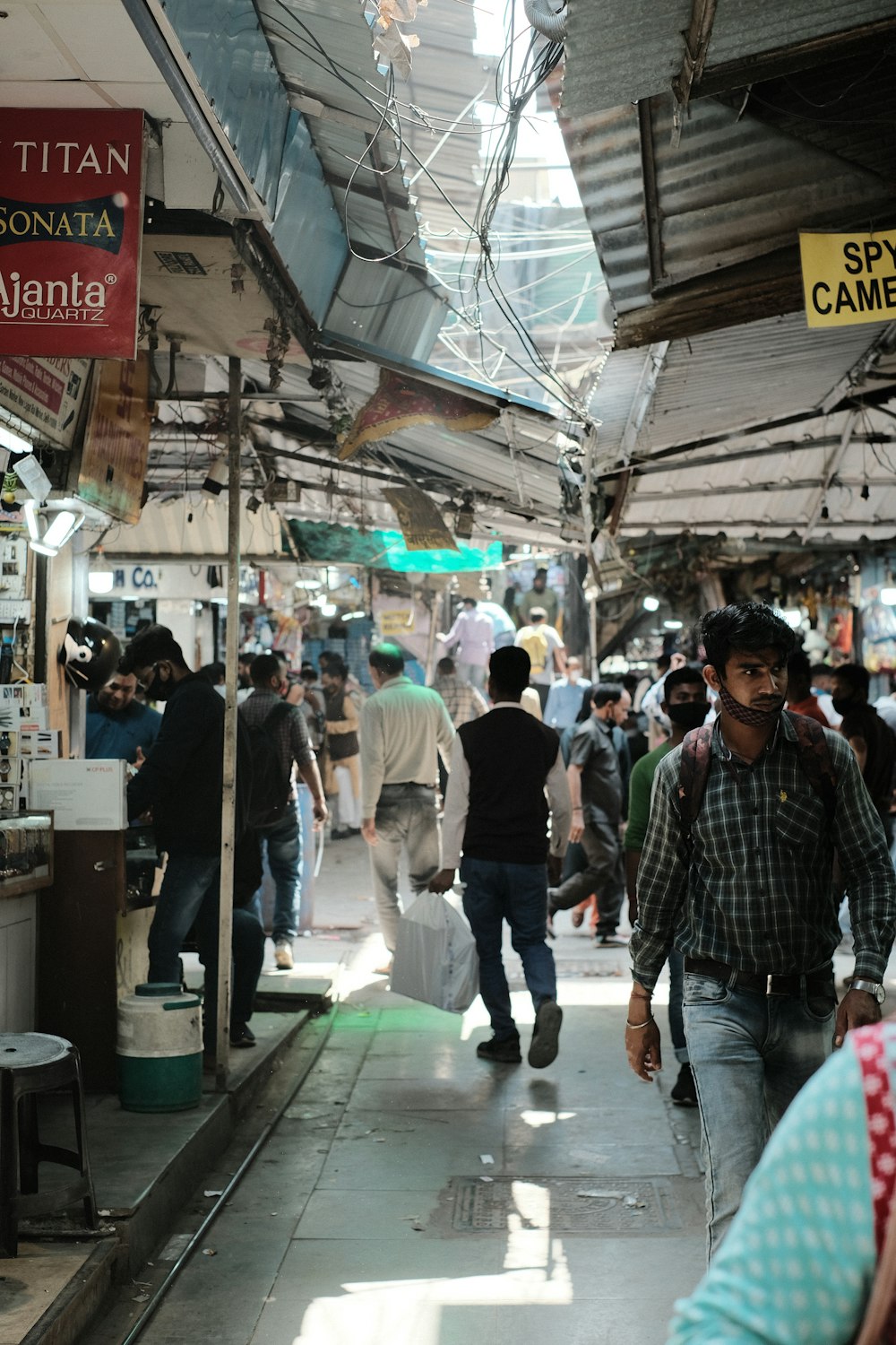 a group of people walking around a market