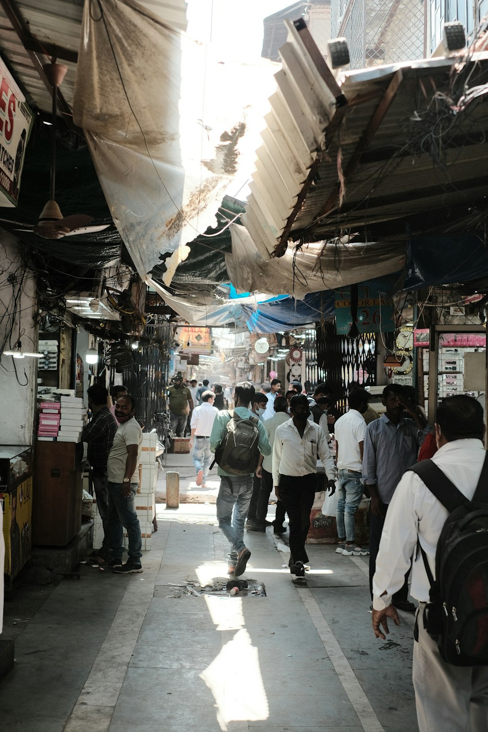 a group of people walking down a narrow street