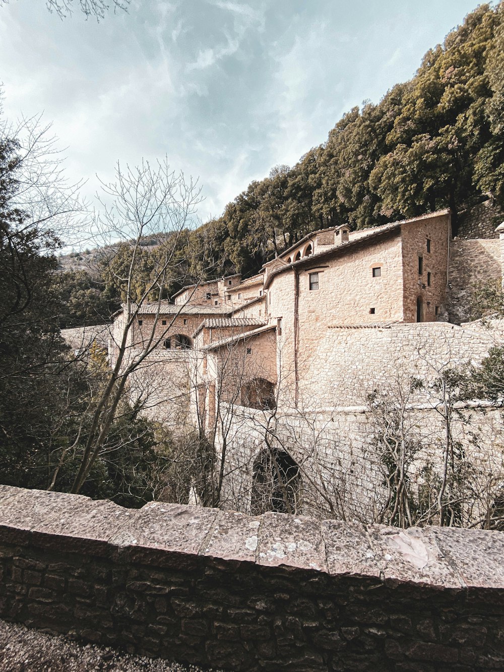 a stone building sitting on the side of a mountain