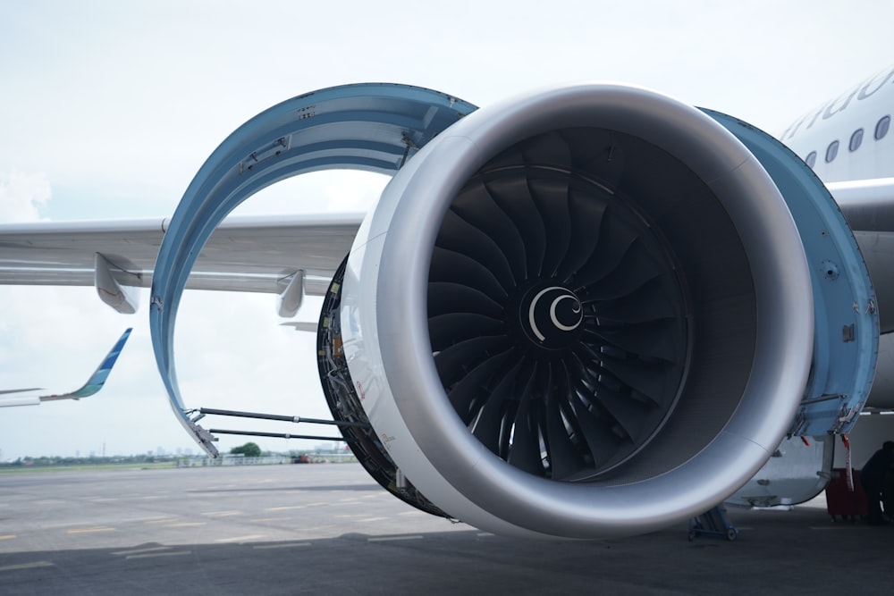 a large jet engine sitting on top of an airport tarmac