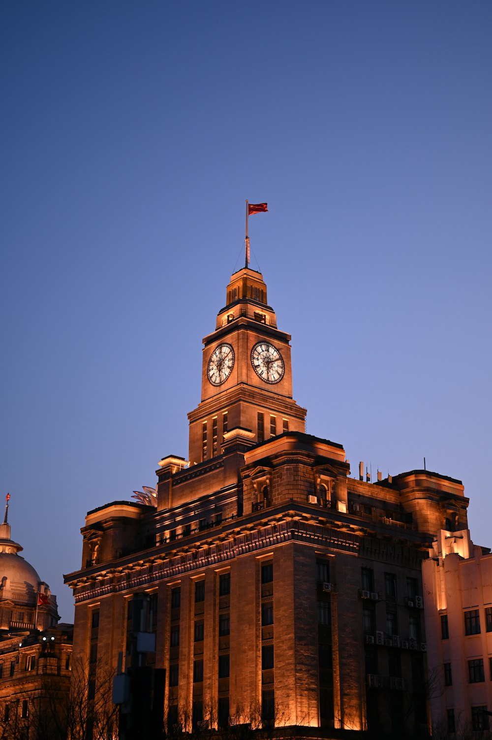 a building with a clock tower lit up at night