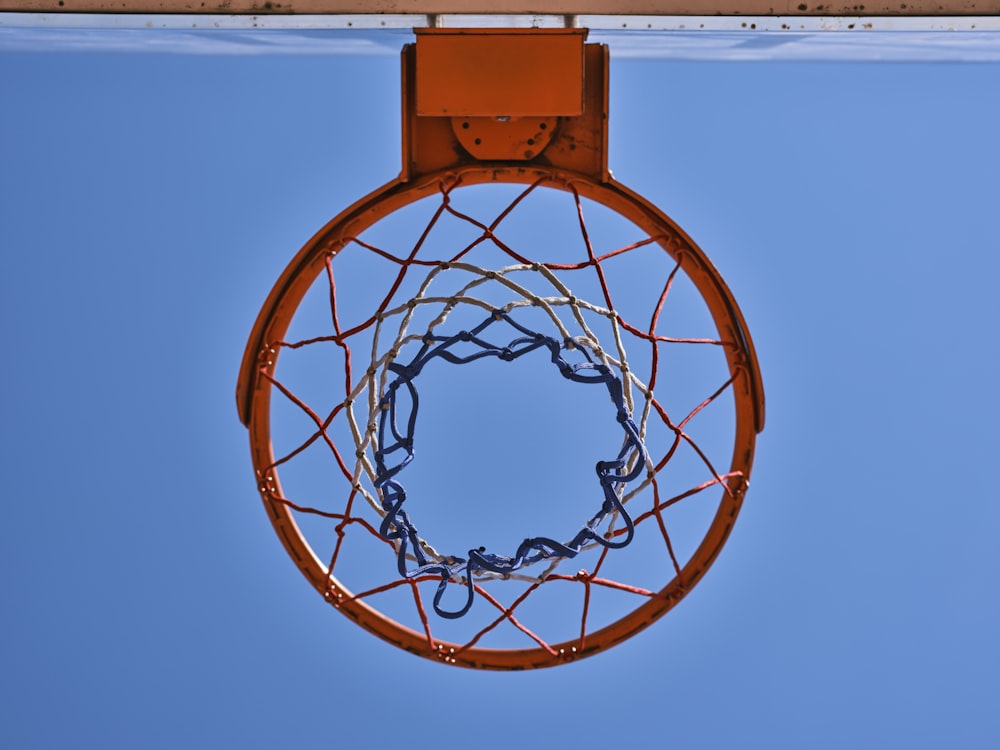 a basketball hoop with a blue sky in the background