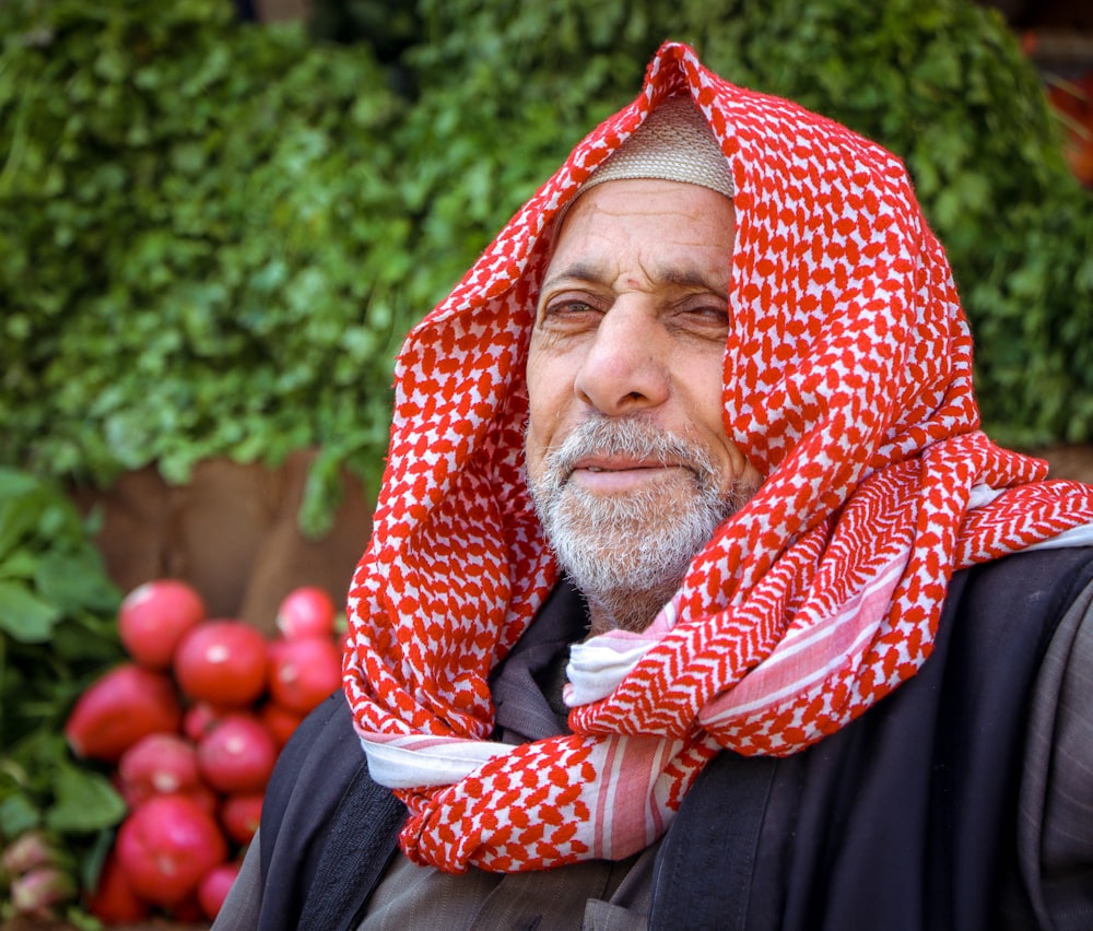 a man with a red and white scarf around his head