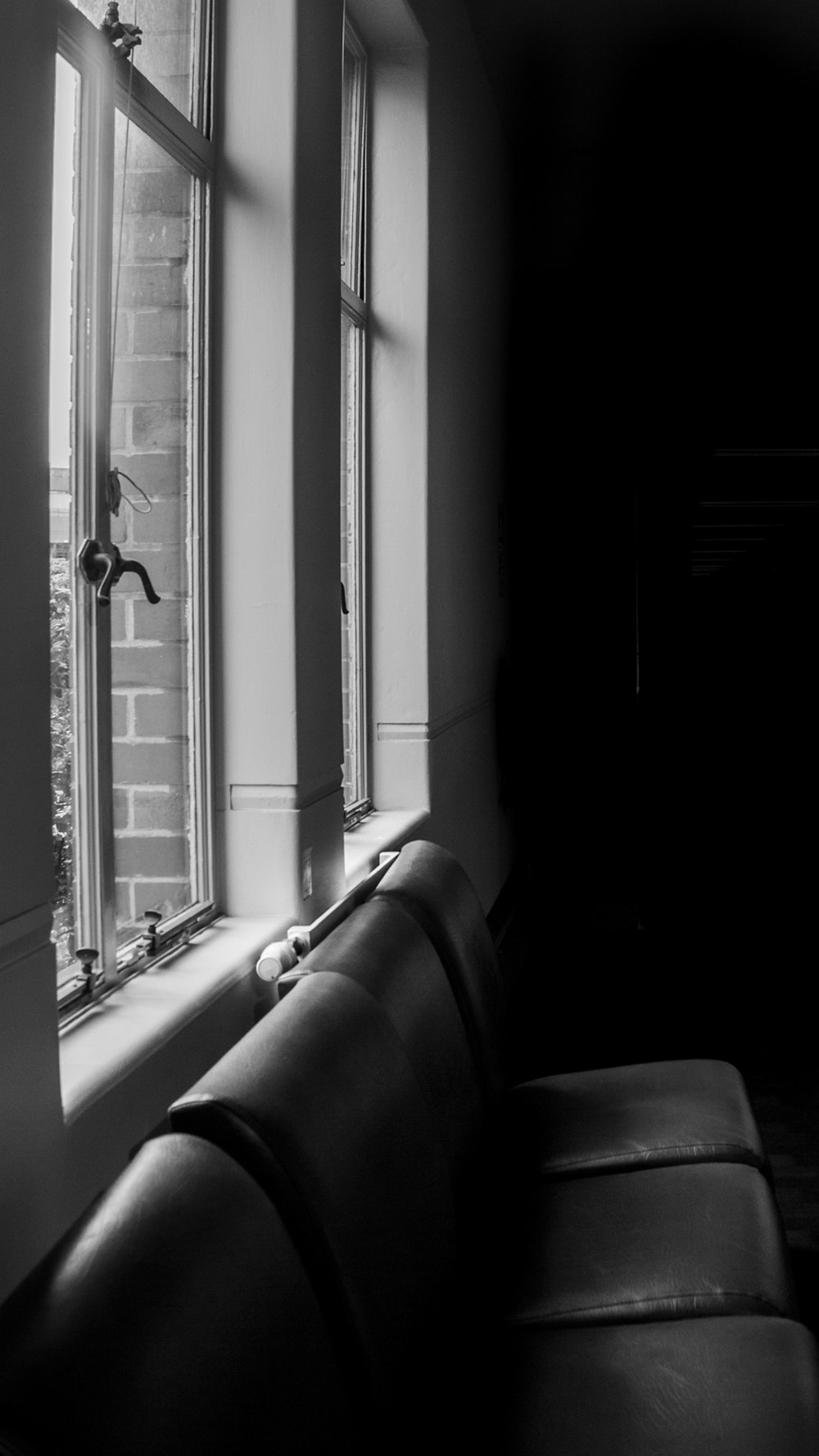 a black and white photo of a window sill