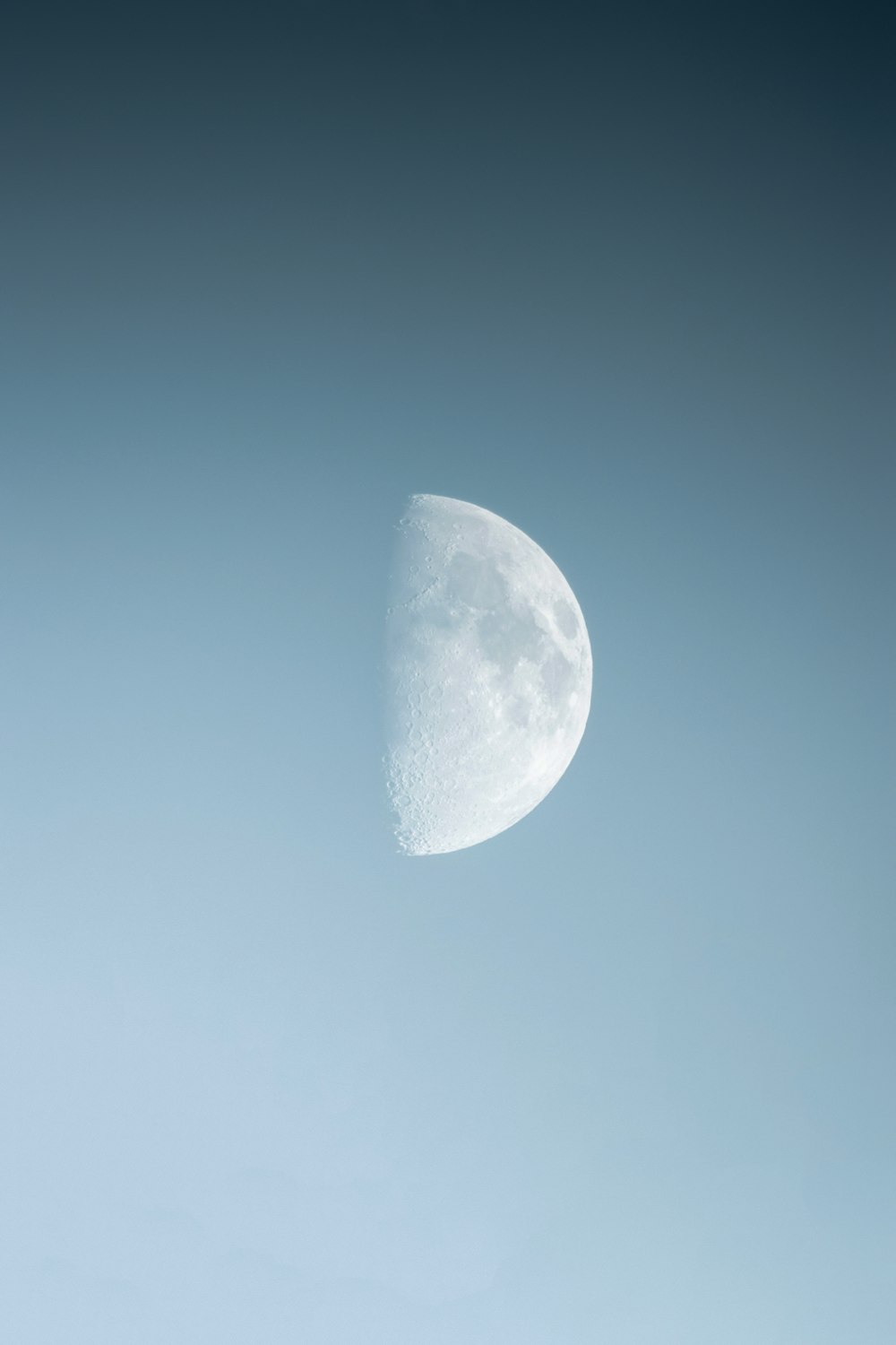 a half moon is seen in the sky