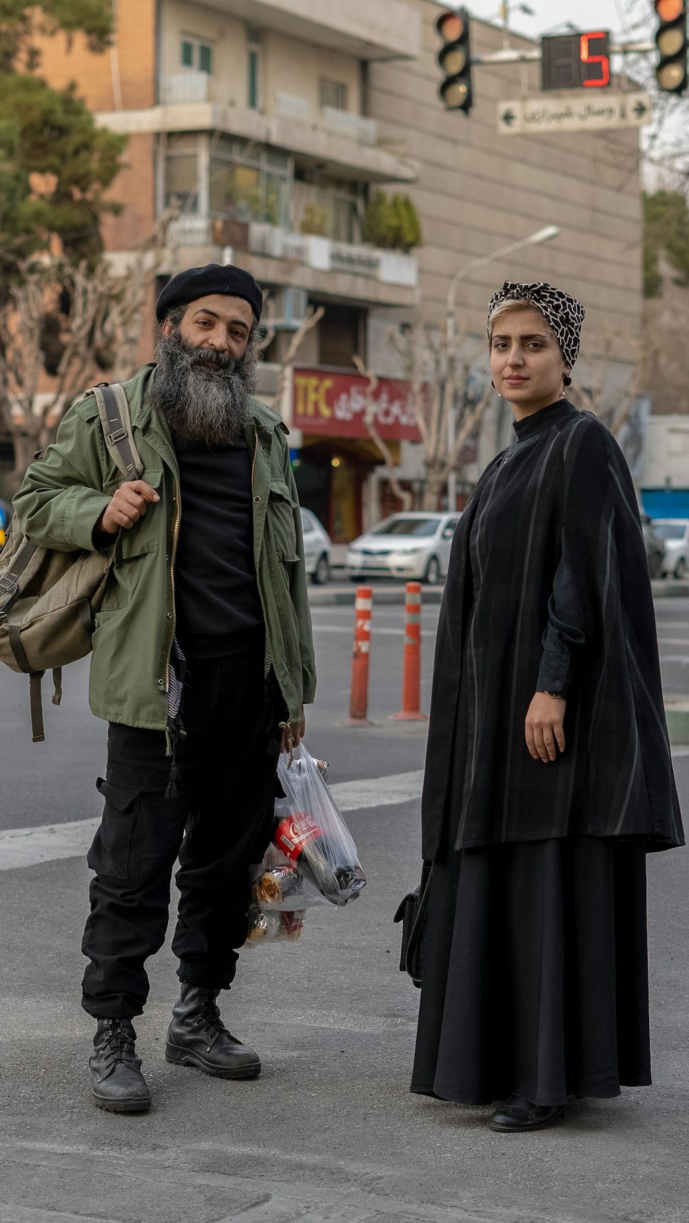 a man and a woman standing in the middle of a street
