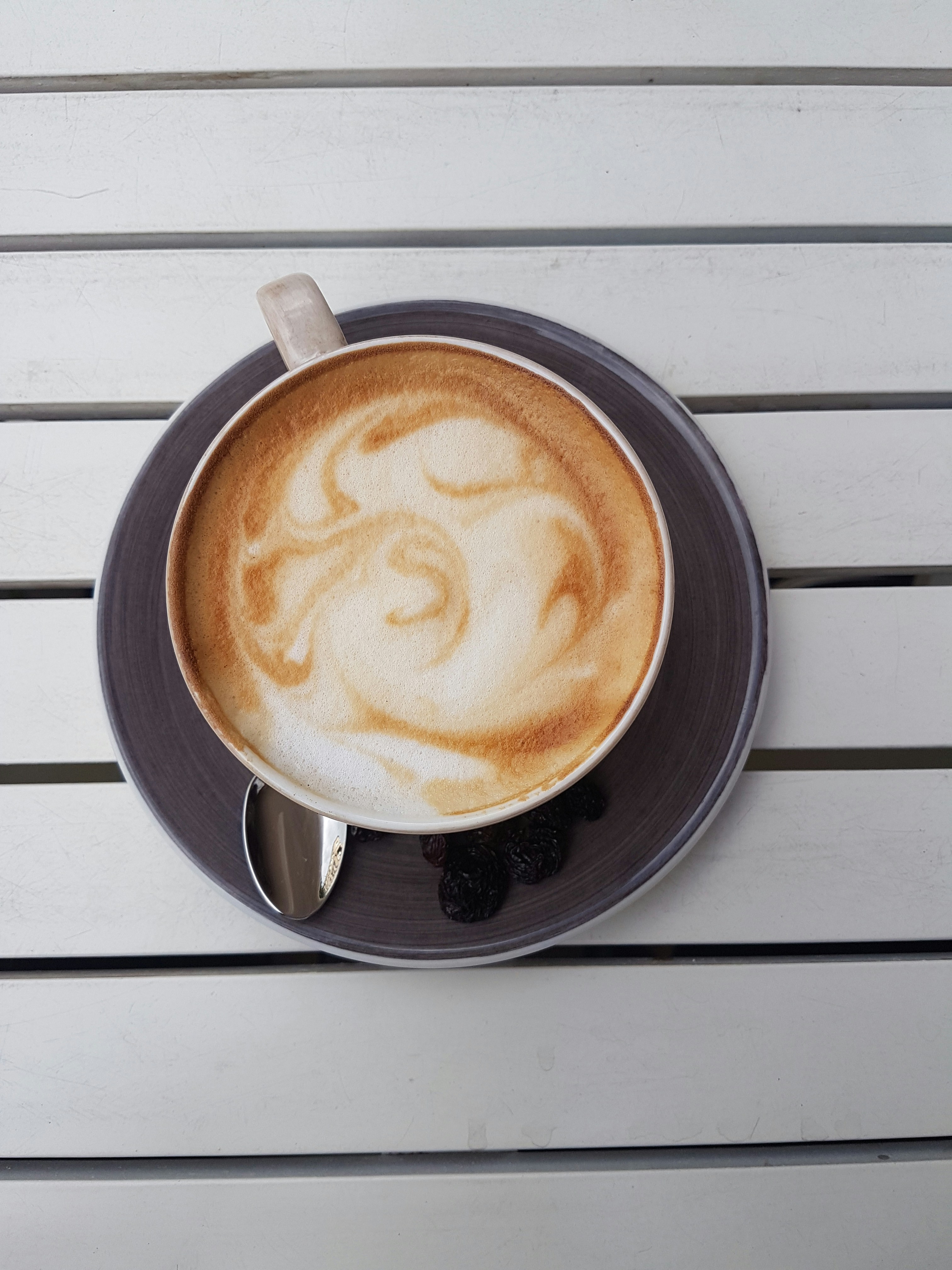 a cappuccino on a saucer on a table