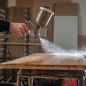 a person using a grinder on a wooden table