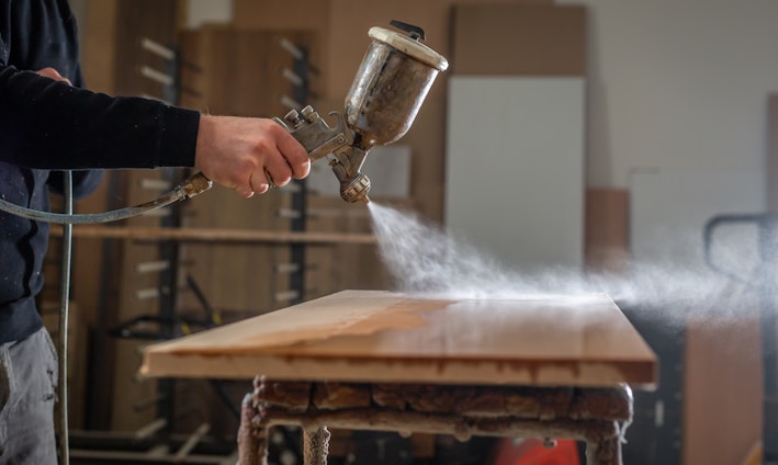a person using a grinder on a wooden table