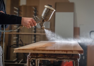 a person using a grinder on a wooden table