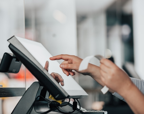 a person is using a pos machine in a store