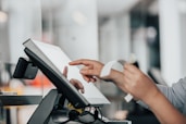 a person is using a pos machine in a store