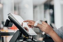 a person is using a pos machine in a store