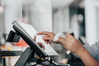 a person is using a pos machine in a store