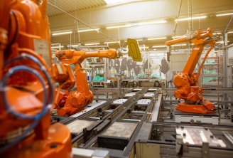 a factory filled with lots of orange machines