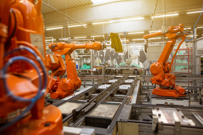 Robotic handling arms working along an automated production line