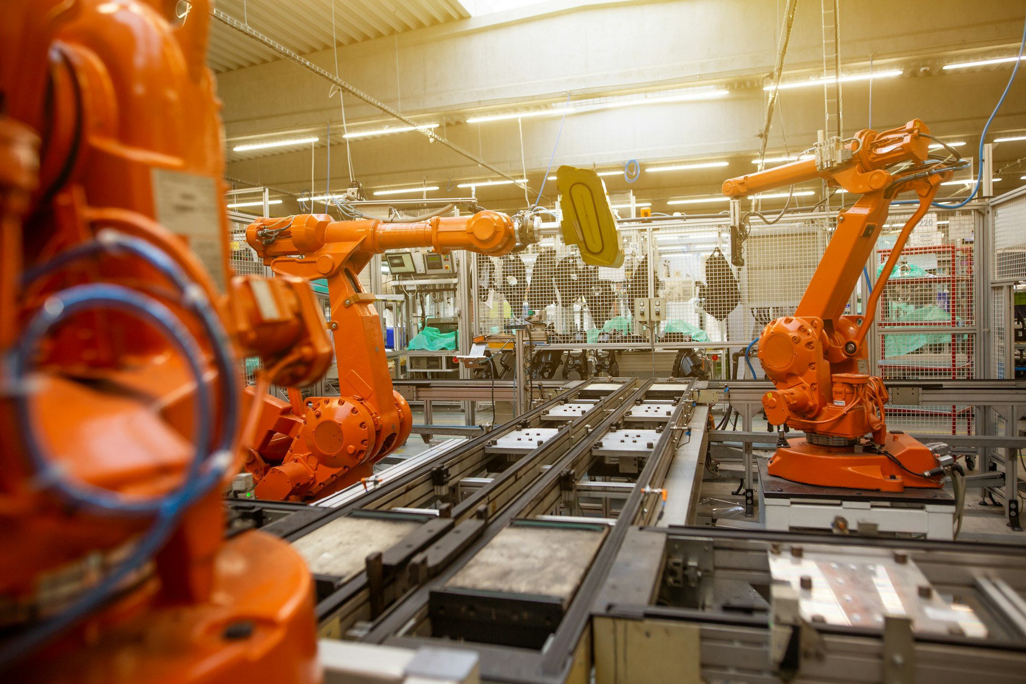 Automatic robots in industrial factory assembling car parts