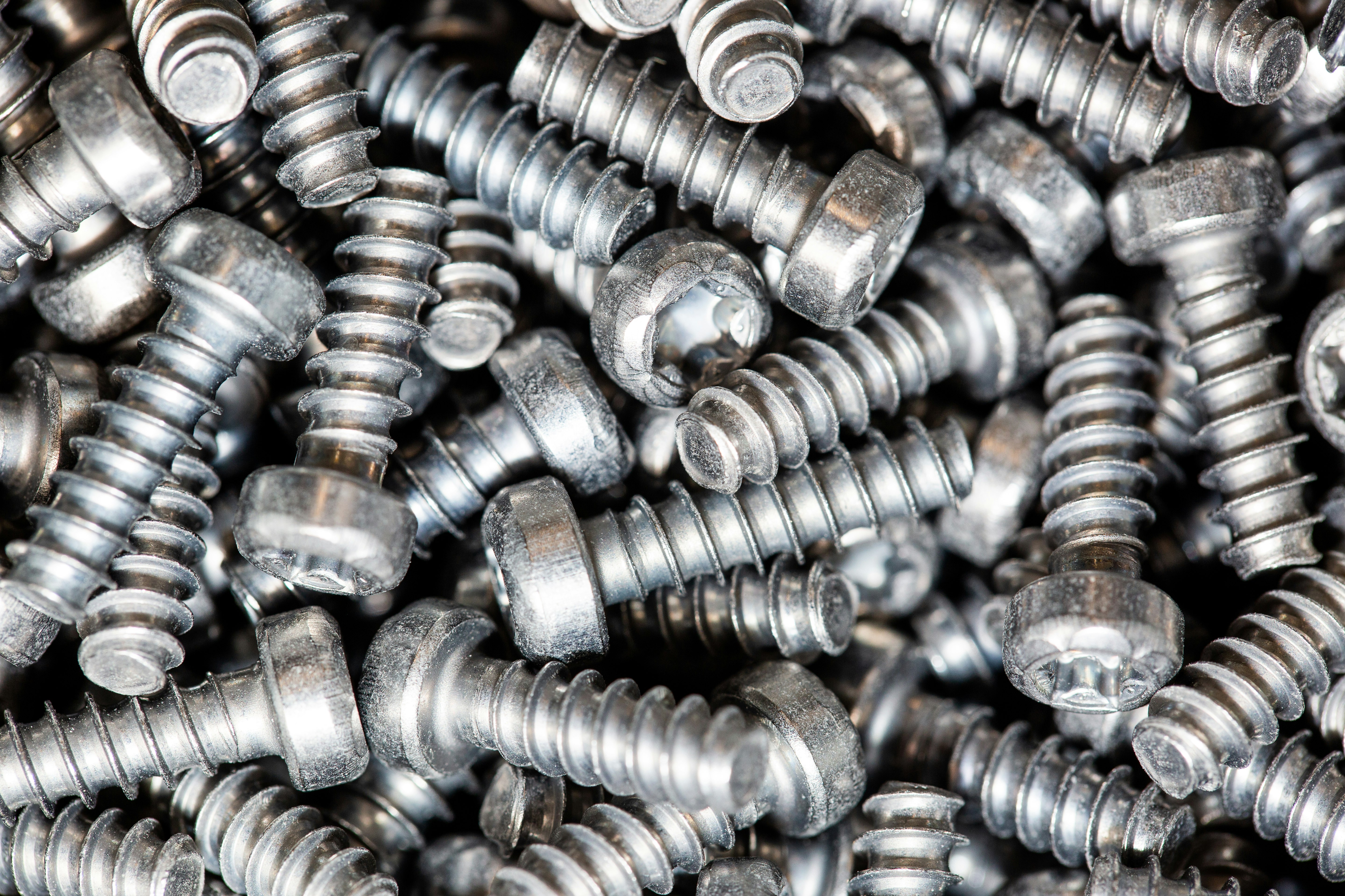 A huge arrenge of taping metal or iron screws, screws as a background, wallpaper or texture, industrial background and concept