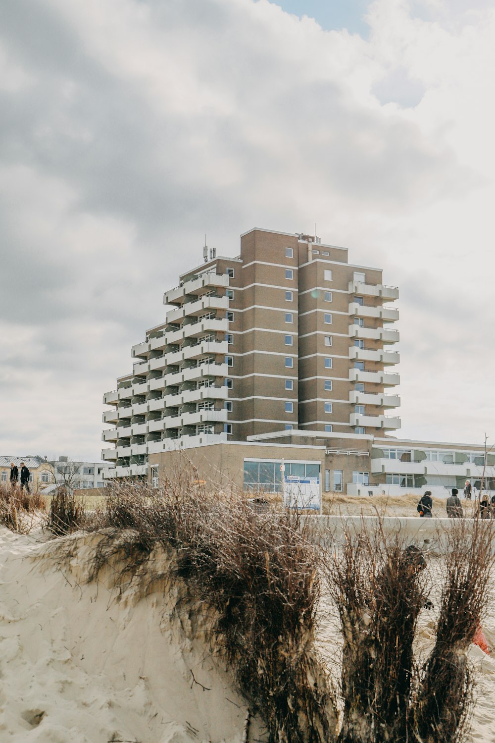 a tall building sitting on top of a sandy beach