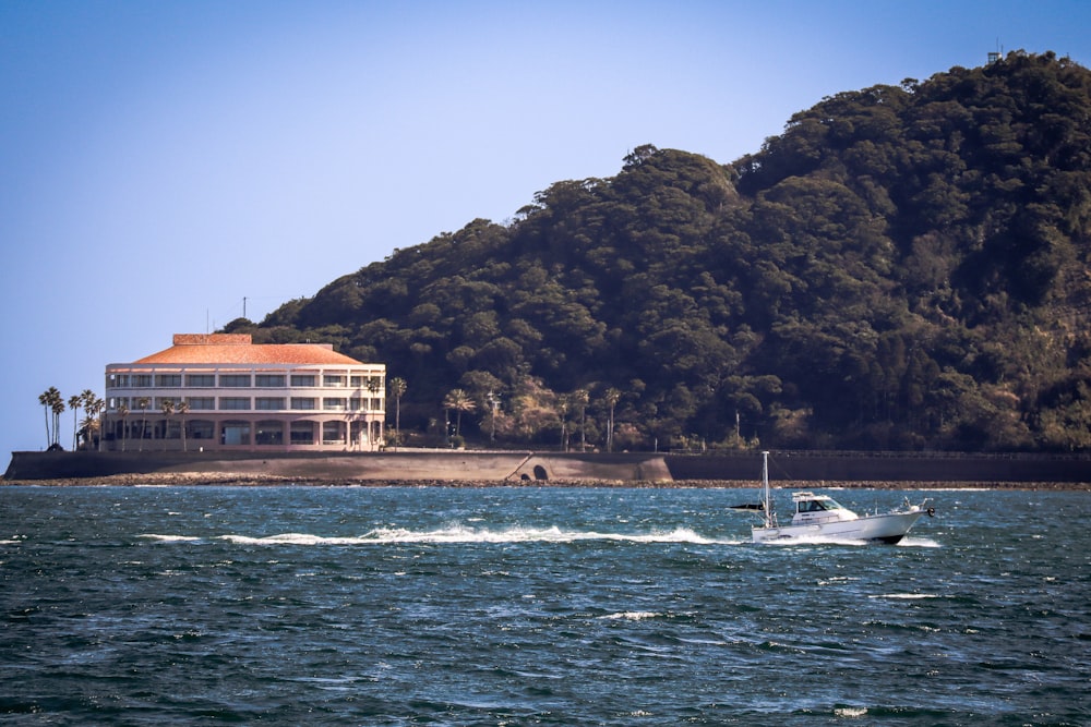 a boat in the water near a large building