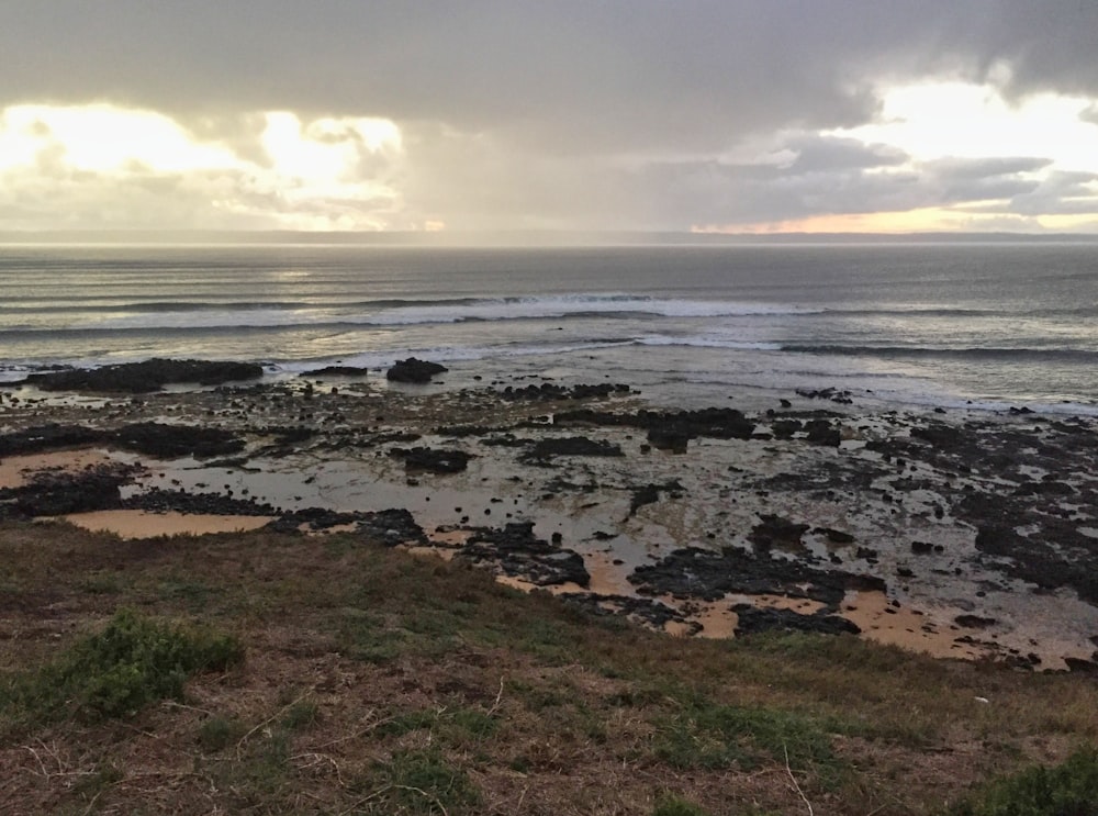 a view of the ocean from the top of a hill