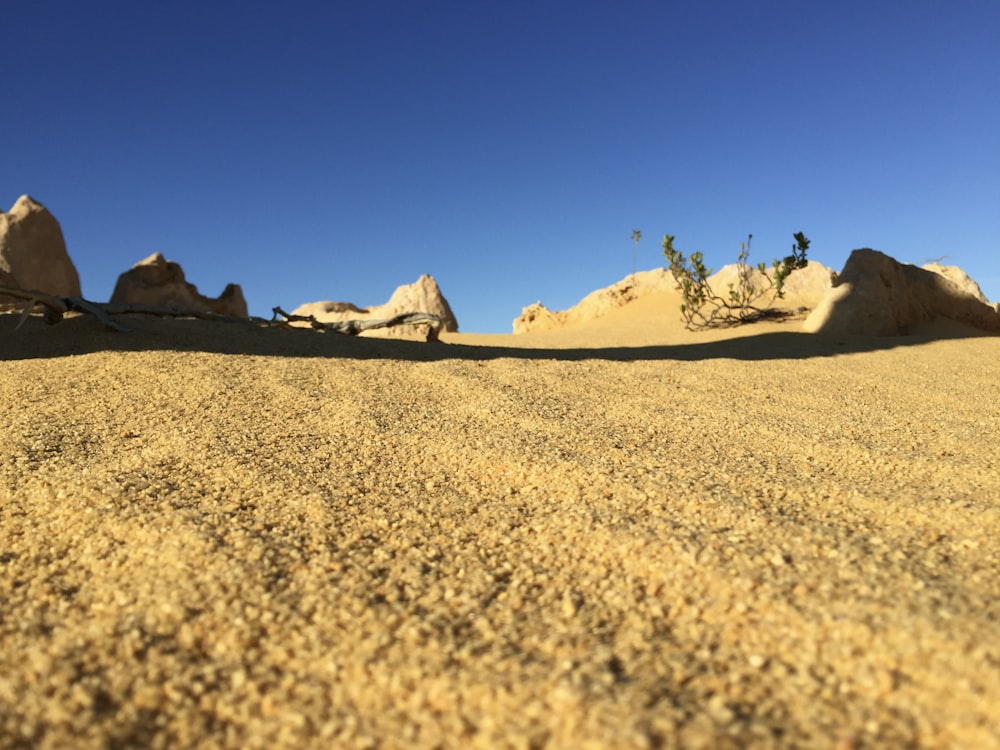 a desert landscape with rocks and a blue sky