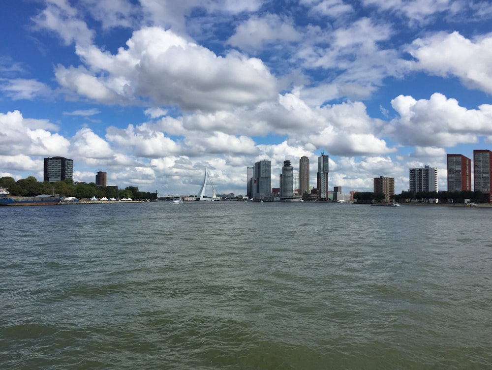 a body of water with a city in the background