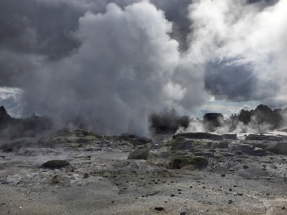 a large group of steam rises from the ground