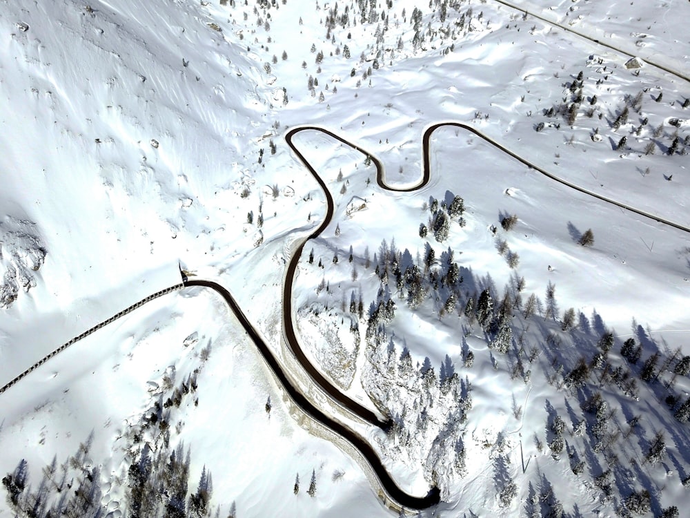 a winding road in the middle of a snowy mountain